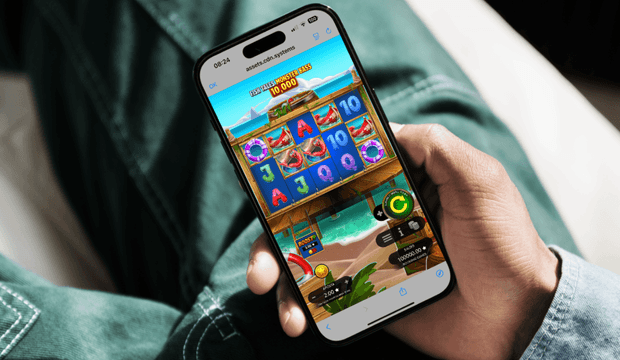 Homem a jogar slot Fish Tales Monster Bass